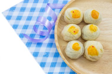 Çin böreği Mung fasulye veya Mooncake yumurta sarısı ahşap tabak ve kaşık ile kumaş şerit çizgili