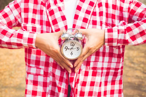 Young woman with alarm clock in a hand. vintage stype — Stock Photo, Image