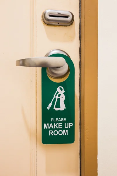 Please make up room sign on door knob in hotel closeup