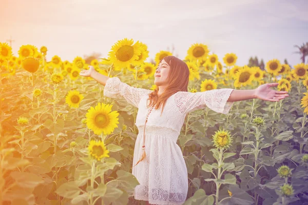 stock image Beauty woman with field of sunflowers 