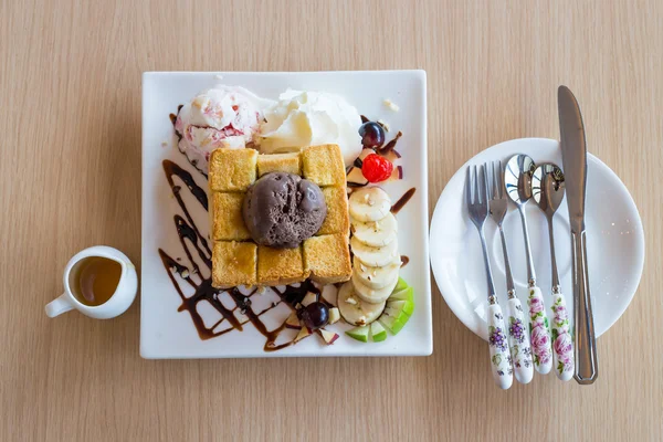 Honey toast whipping cream with chocolate ice cream and spoon fork knife on wood background — Stock Photo, Image