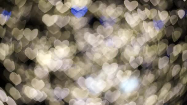 Videos of hearts in blur, they flash white and blue. Festive illumination. February 14. — Stock Video