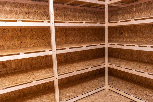 OSB racks, shelves are designed for storing things. Dressing room in the house. Organization of spaces in the house. Shelves in the garage.