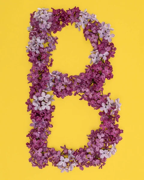 The letter B is lined with lilac flowers on a yellow background. For lettering, composing words. — Stock Photo, Image