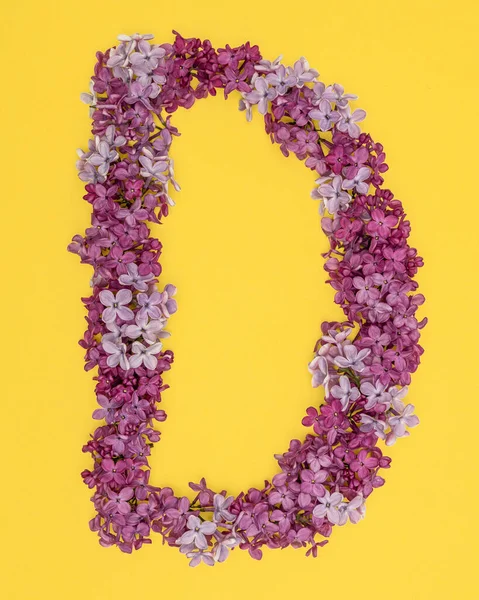 The letter D is lined with lilac flowers on a yellow background. For lettering, composing words. — Stock Photo, Image
