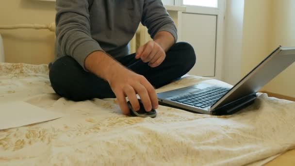 Чоловік зосередився на роботі або соціальних мережах на своєму ноутбуці — стокове відео