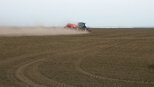 Traktor pluhy pokladny pluhy a semen na hřišti — Stock video