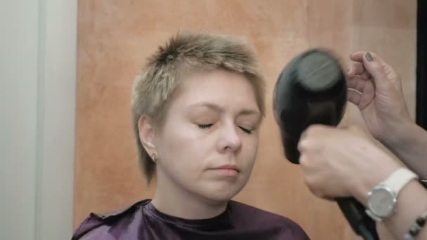 Hairdresser Dries And Styles Short Hair Blond Head Stock Video