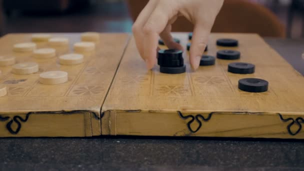 Close up of checkers on checkerboard on the table — Stock Video