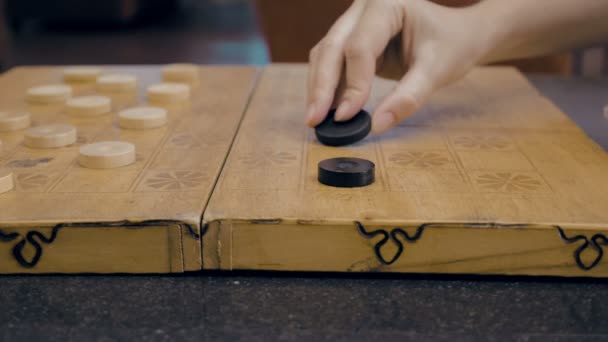 Close up of checkers on checkerboard on the table — Stock Video