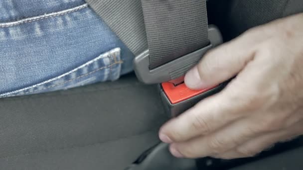 Mannenhand unfastening auto veiligheid dragen van de veiligheidsgordel — Stockvideo