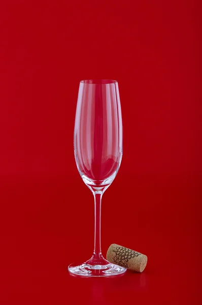 Wine glass with cork over red — Stock Photo, Image