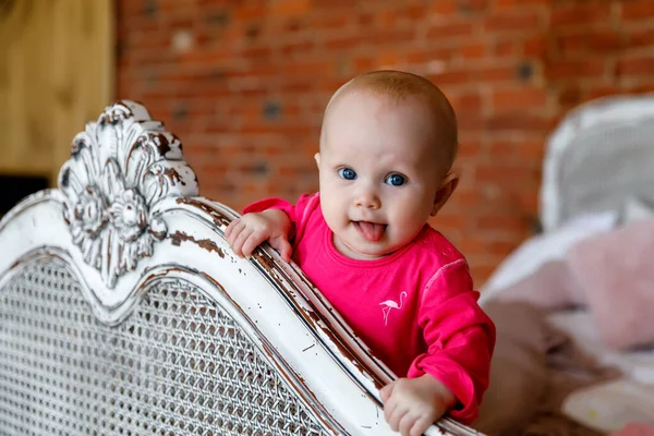 可爱的蓝眼睛6个月大的小女孩 穿着鲜红色的衣服 头戴复古床 漂亮的金发美女迷人的孩子在特写中表现出感情 健康儿童和养育子女的概念 — 图库照片