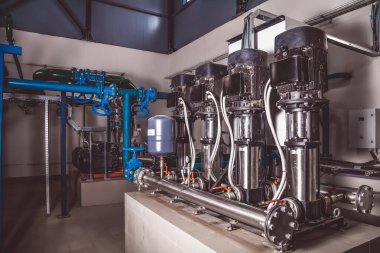 Su pompasının, vanaların, basınç göstergelerinin, makine dairesinin içindeki motorların endüstriyel içleri. Endüstriyel bir odada valf ve pompalar. Kentsel modern güçlü boru hatları ve pompalar, otomatik kontrol sistemleri