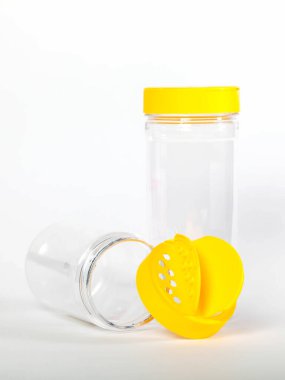 Cans for storing bulk products with yellow lids on white isolated background. Transparent plastic container with lid for storing food and bulk product. An empty jar for food. Copy space