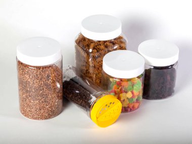 Cans for storage bulk products with food on white isolated background. Transparent plastic container with lid for storing food and bulk product. Cereals and bulk products in jars for food. Copy space