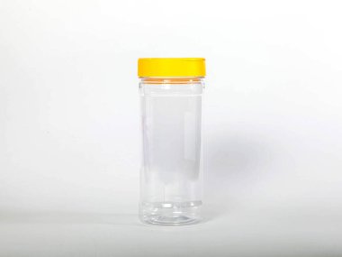 Cans for storing bulk products with yellow lids on white isolated background. Transparent plastic container with lid for storing food and bulk product. An empty jar for food. Copy space