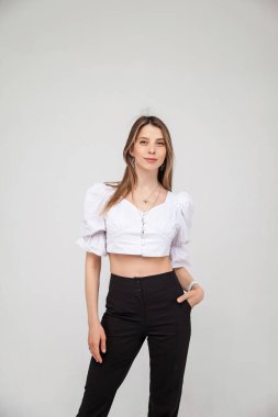 Saçları neşeli bir şekilde gülümseyen, mutlu ve kaygısız hissederken duygularını gösteren güzel sarışın bir kadının sıradan portresi. Genç, tatlı, neşeli kız beyaz arka planda kameraya bakıyor.