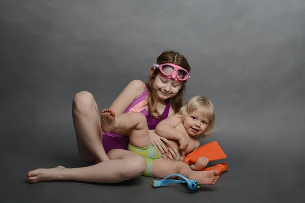 Older Sister Young Brother Having Fun Children Swimsuits Put Fins Stock Photo