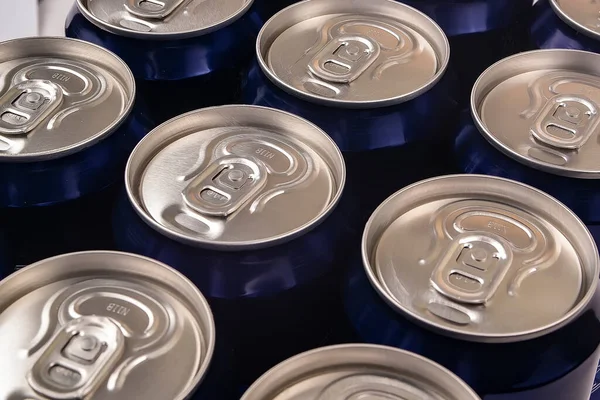 several aluminum cans for beer or carbonated water stand next to each other
