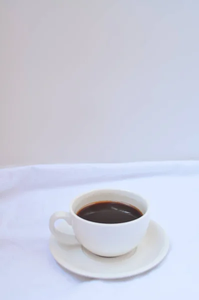 cup of coffee in bed with copy space vertical view