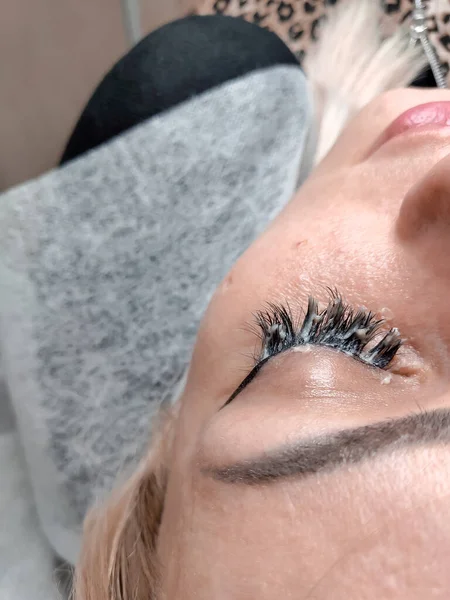 Removing lash extensions in beauty salon macro eye