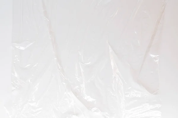 Plástico fino e claro Envoltório no fundo branco — Fotografia de Stock