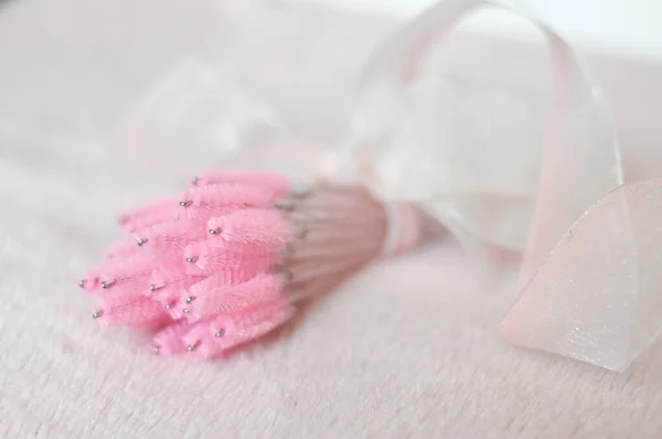 Pink brushes for eyelash extensions and brows in beauty salon