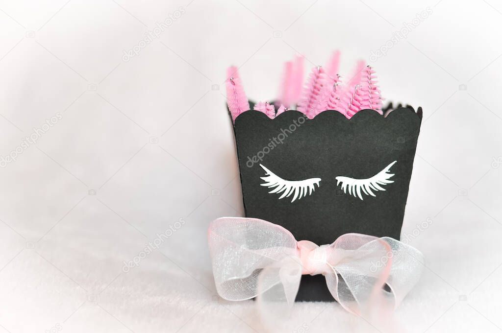 Pink brushes for eyelash extensions and brows in beauty salon 