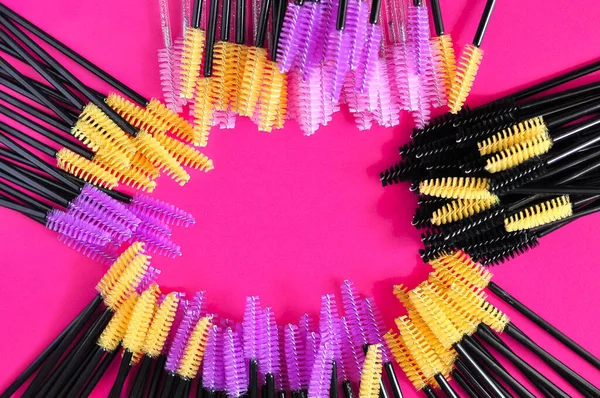 Cute colored brushes for hairing eyelash extensions and brows in beauty salon . High quality photo