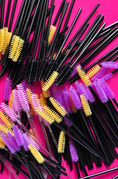 Cute colored brushes for hairing eyelash extensions and brows in beauty salon . High quality photo