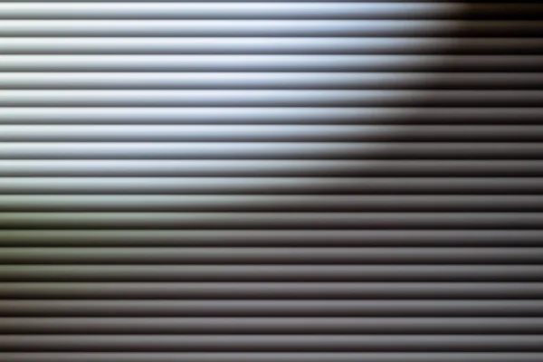 blinds in dim light. Texture or background. Abstraction. Blinds on the window. Gray depressed background