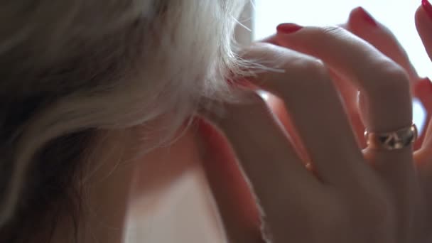 Mladá žena klade na krásné náušnice — Stock video