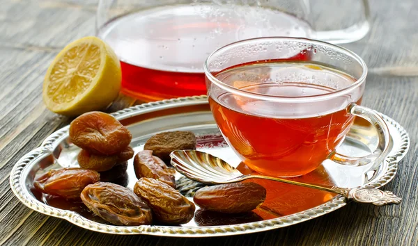 Cup of tea with dried fruits on a tray — Stock Photo, Image