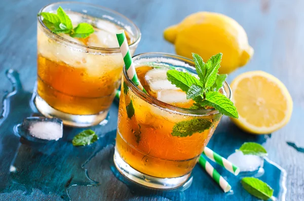 Fresh cold iced tea with mint, ice and lemons, refreshing drink