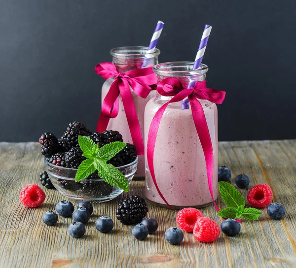 Vitamin smoothie with berries,  on wooden dark background