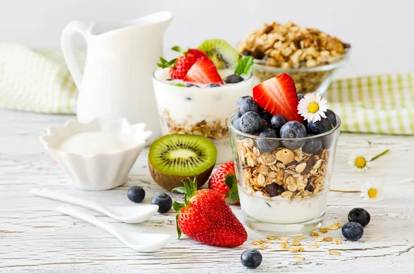 Healthy breakfast with muesli in glass, fresh berries and yogurt
