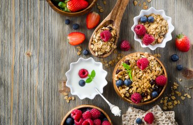 Fresh healthy breakfast with granola and berries, copy space bac