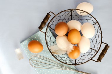 Brown and white eggs for cooking on blue sample text  background