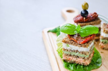 Rye granary bread sandwich cake with curd and antipasto copy spa