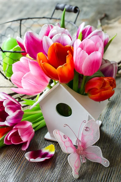 Bunch of flowers in birdshouse vase for mothers day — Stock Photo, Image