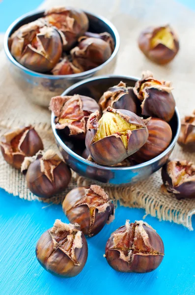 Roasted chestnuts in bowls on sackcloth 
