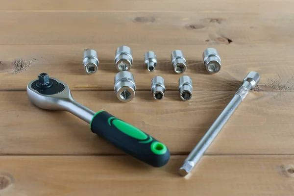 A multipurpose precision tool kit set box showing wrenches with different interchangeable bit head sizes arranged in rows to cater to varying types of screws, nuts and bolt types - closeup top view.
