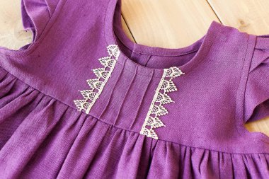 Açık mor bir elbise. Eski ahşap bir arka planda giyinmek.