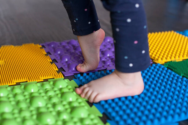little girl walking on massage Mat