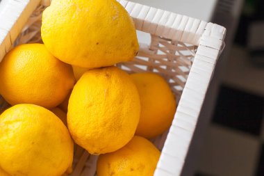 Limonlar beyaz bir sepetin içinde olgunlaşmış.