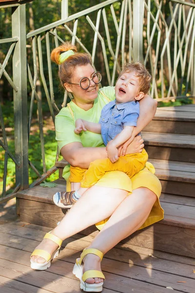Happy Mother Disabled Child Sitting Grass Park Gently Hugging Summer — Stock Photo, Image