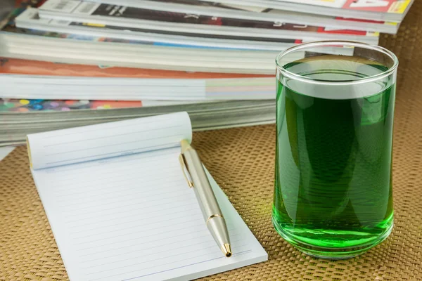 Chlorophyll  in glass and notebook — Stock Photo, Image