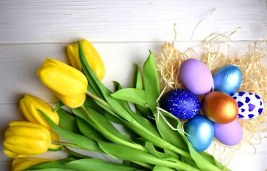 Easter card: yellow tulips and Easter eggs