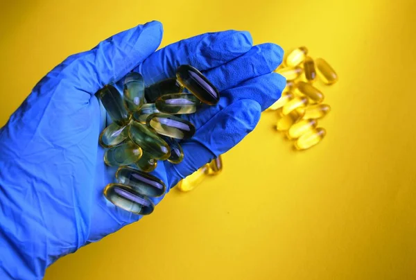 Omega Capsules Girl Hand Blue Background — Stock Photo, Image